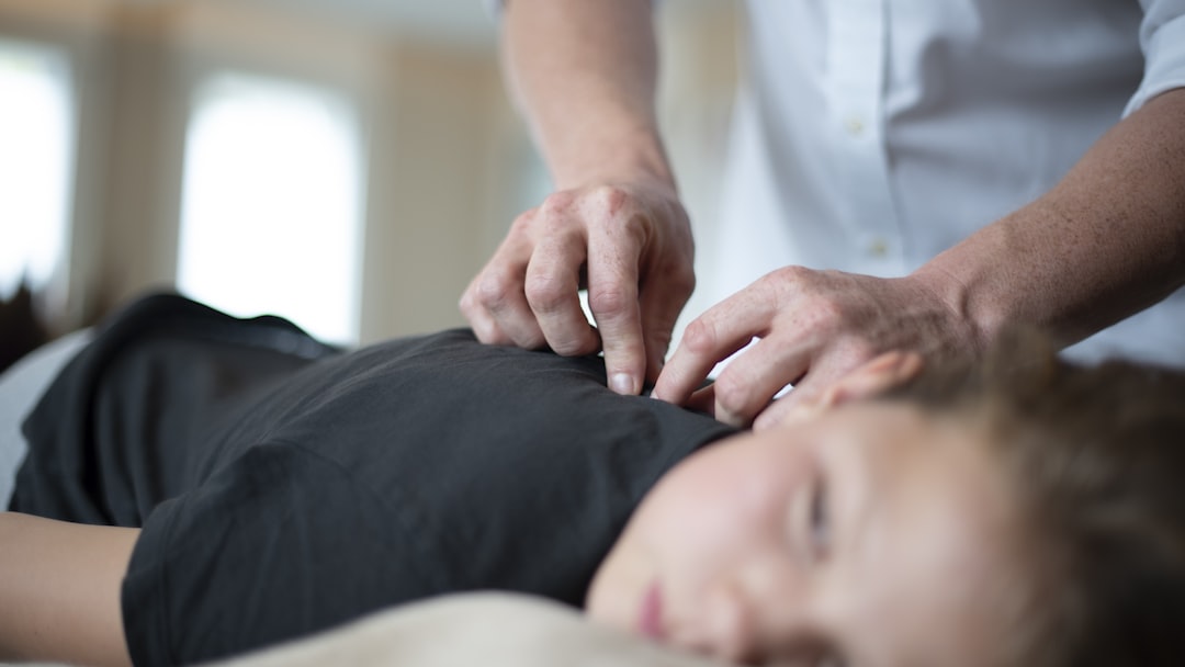 a woman getting a massage from a man in a white shirt