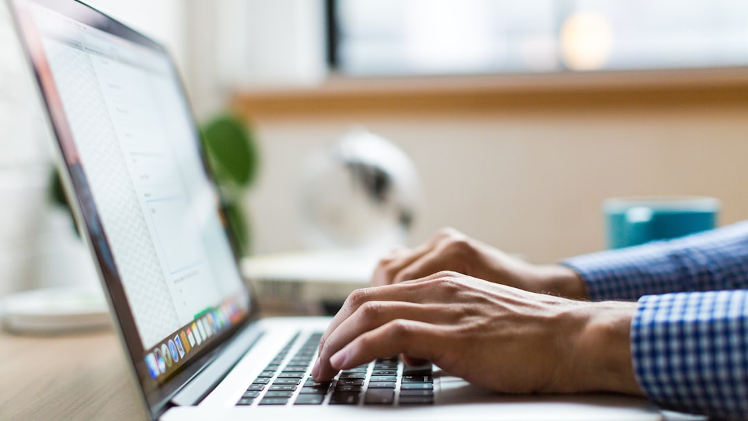 person typing on silver MacBook