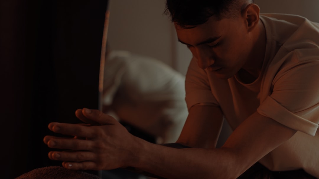 A masseuse is giving someone a back massage.