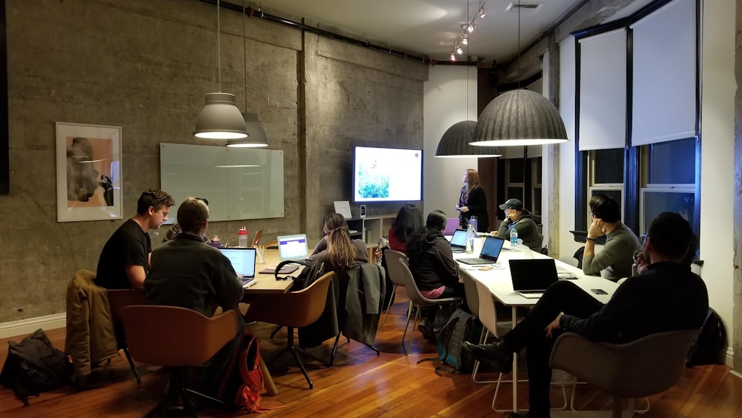people sitting and using laptops