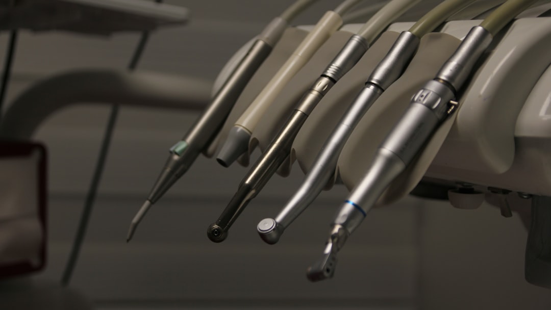 a row of dental instruments hanging from a wall