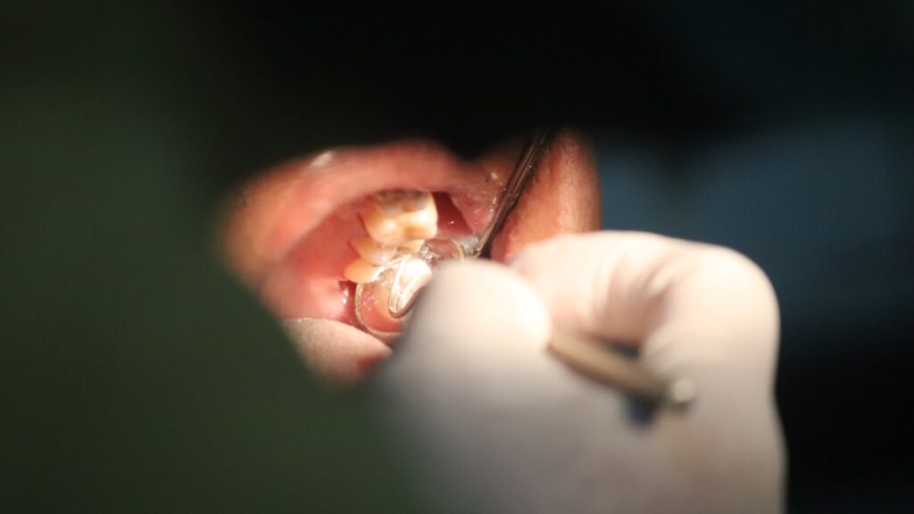a close up of a person holding a tooth brush