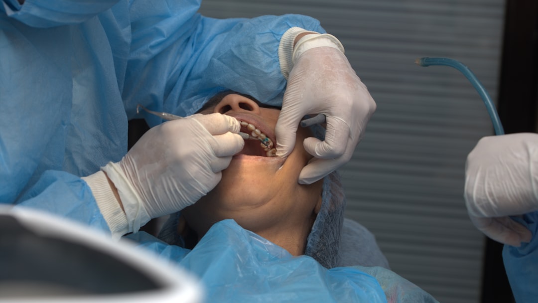 A man getting his teeth checked by a dentist