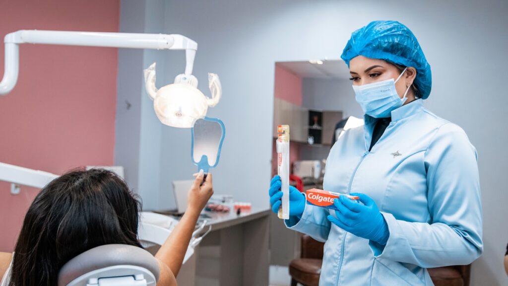 a woman in a dentist's office holding a toothbrush