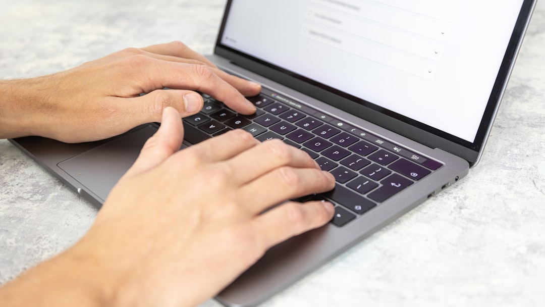 a person typing on a laptop