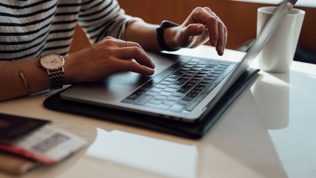 person seated at the table using laptop