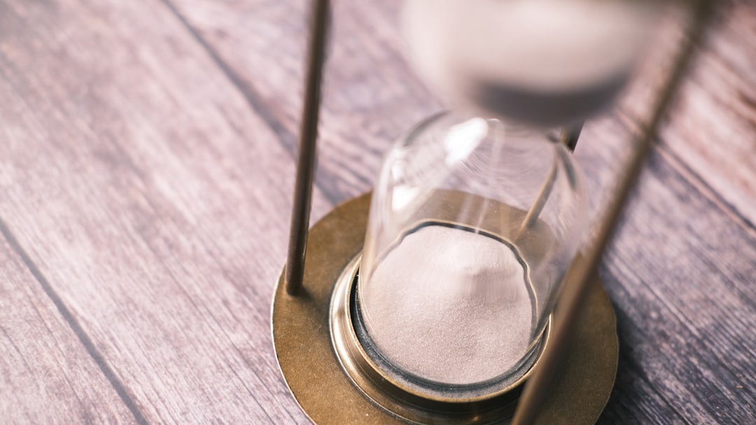 an hourglass sitting on top of a wooden table