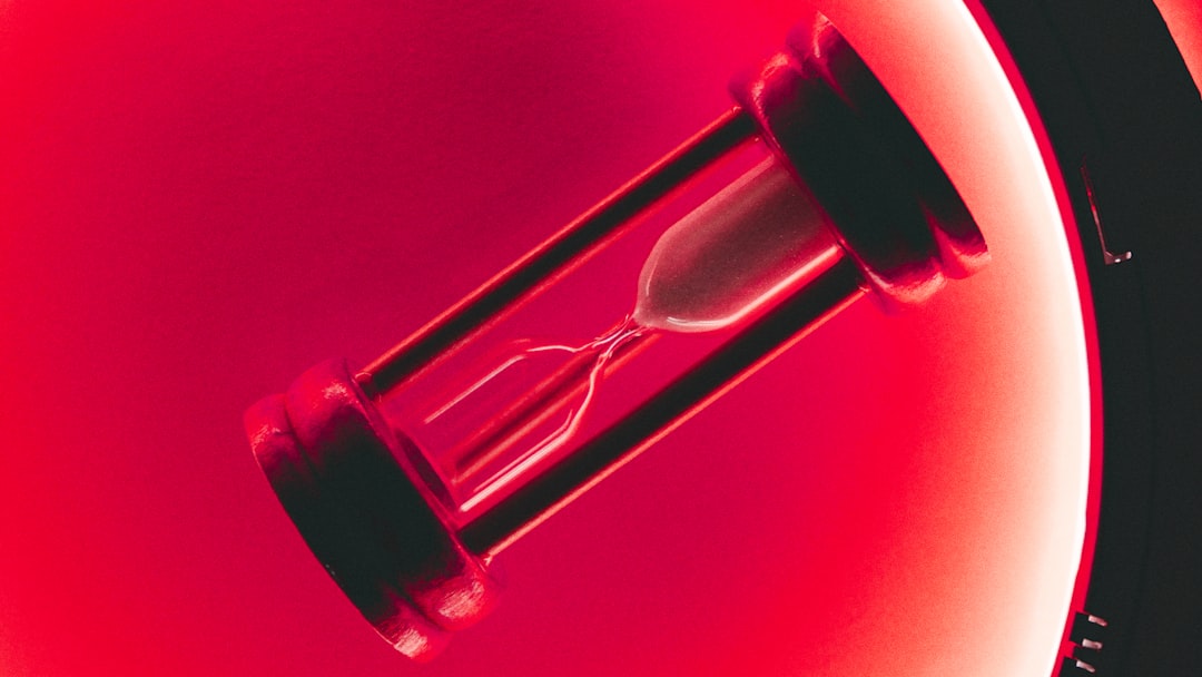 clear hour glass with red background