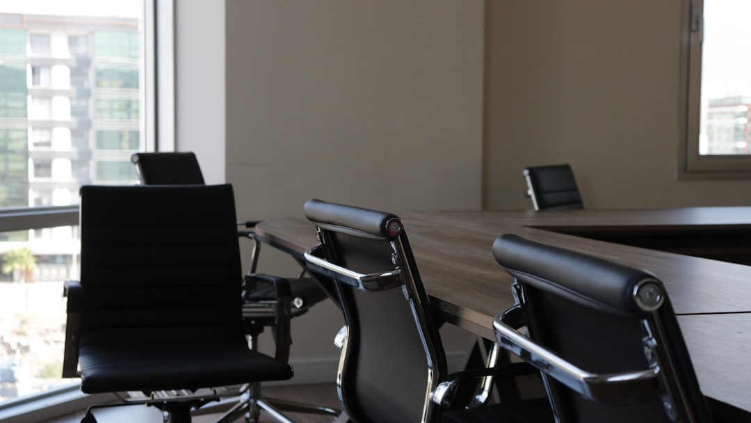five black rolling chars front of desk