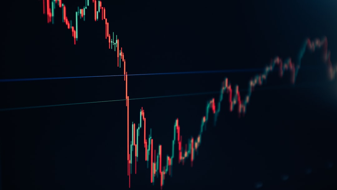 candlestick stock chart on dark screen