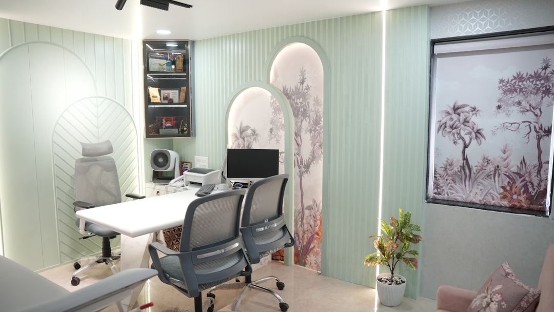Modern office with desk, chairs, and computer.