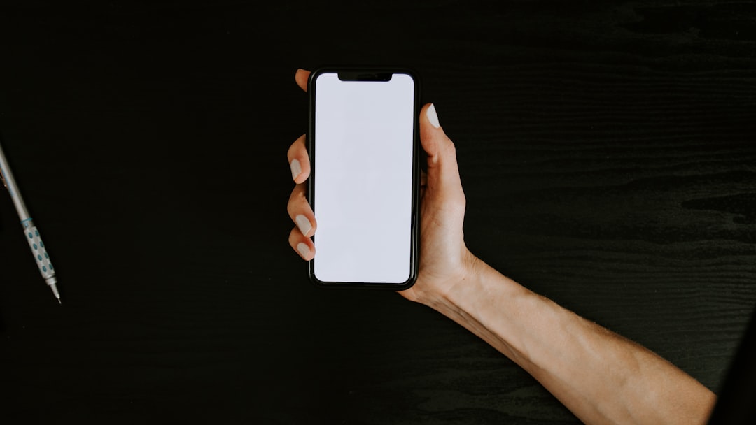 person holding white iphone 5 c