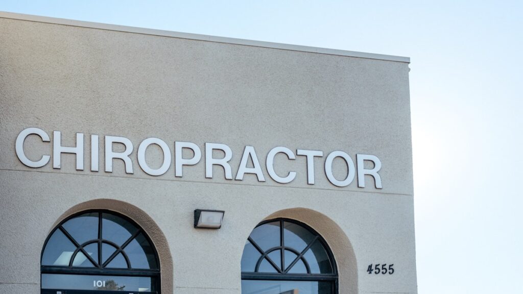 a building with two arched windows and a sign that says chiropractor