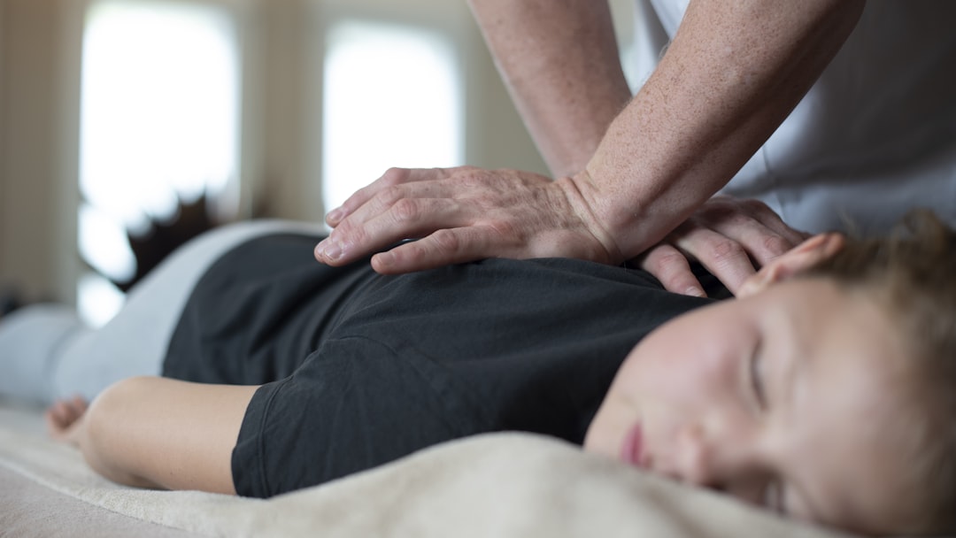 a woman getting a back massage from a man