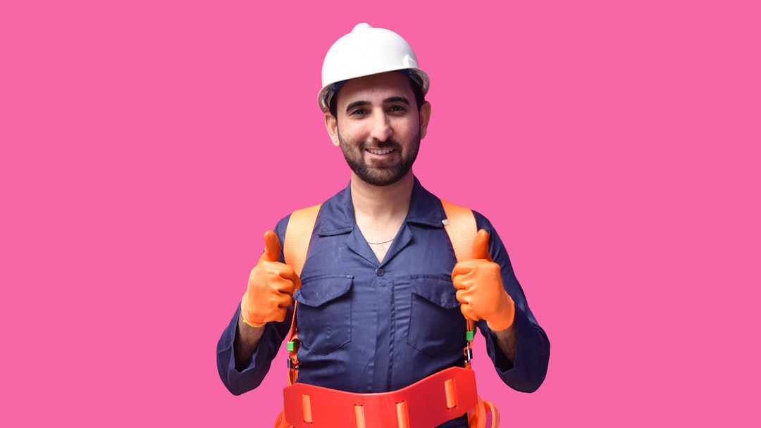 a person wearing a hard hat and holding a yellow tool