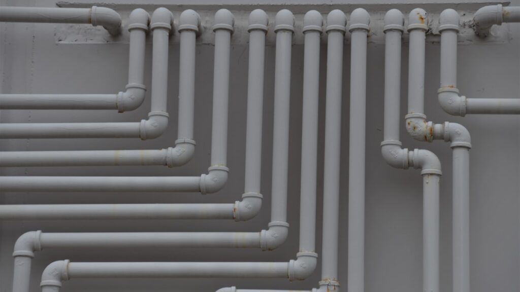 a close up of a bunch of pipes on a wall