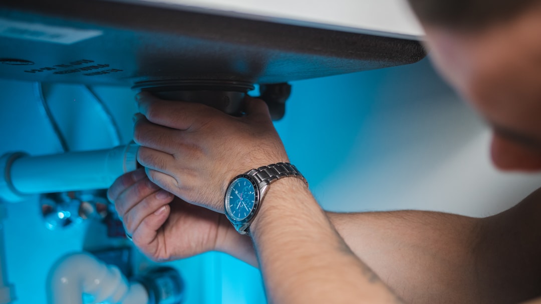 a man fixing a water heater in a room