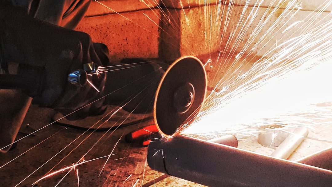 person grinding pipe steel wool photography