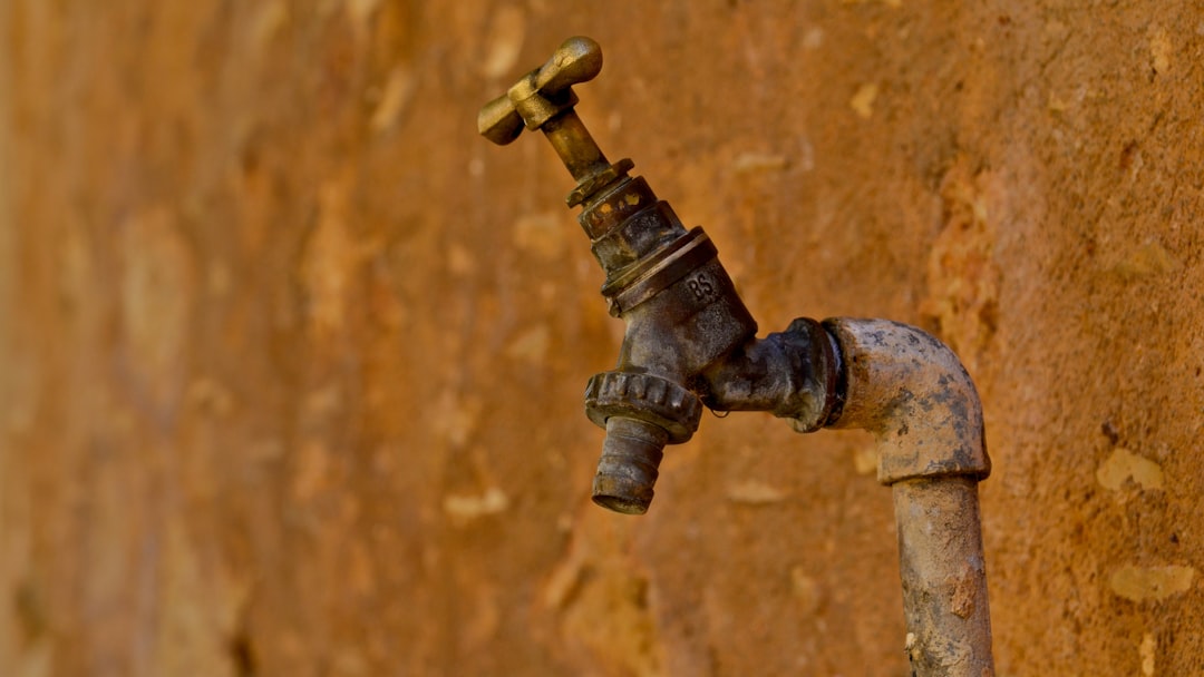 selective focus photography of brown faucet