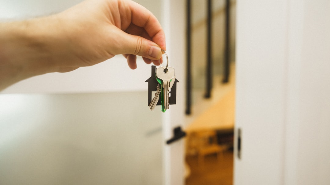 A hand holding a key to a door