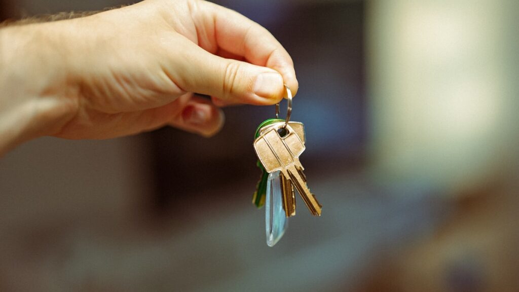 A person holding a bunch of keys in their hand