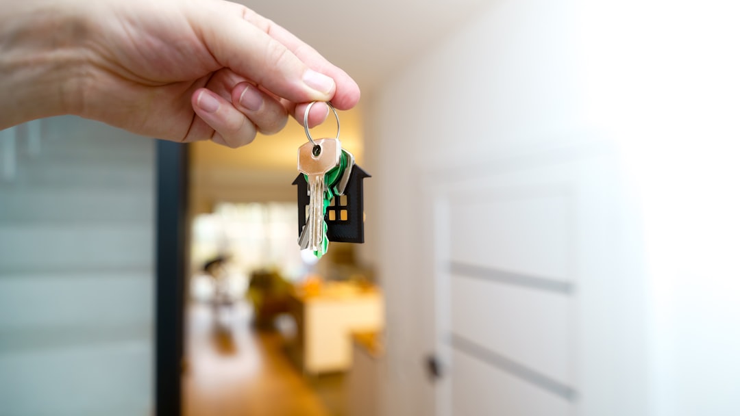 Holding house keys in front of the entrance.