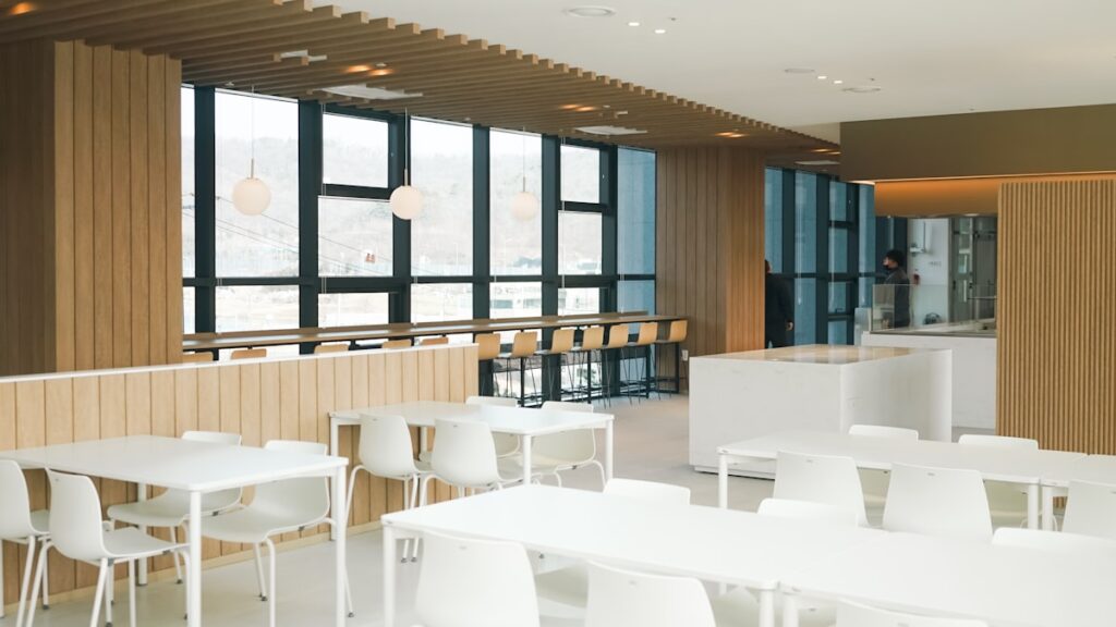 a room with tables and chairs and a bar