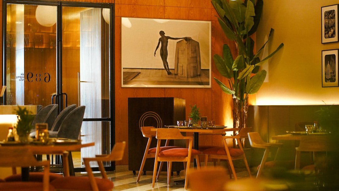 A restaurant with tables, chairs, and pictures on the wall