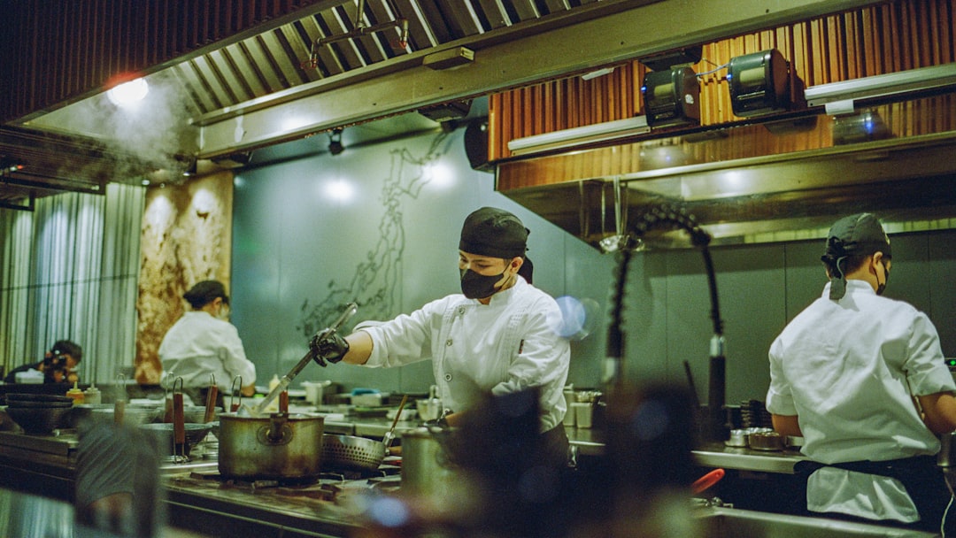 A group of chefs preparing food in a kitchen