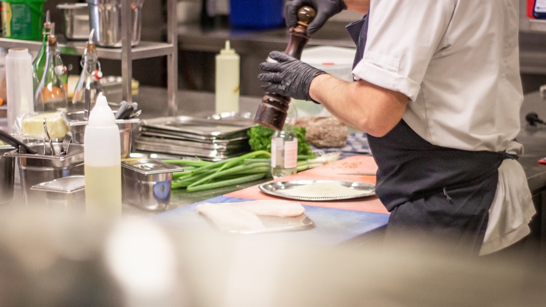 man putting herb on food