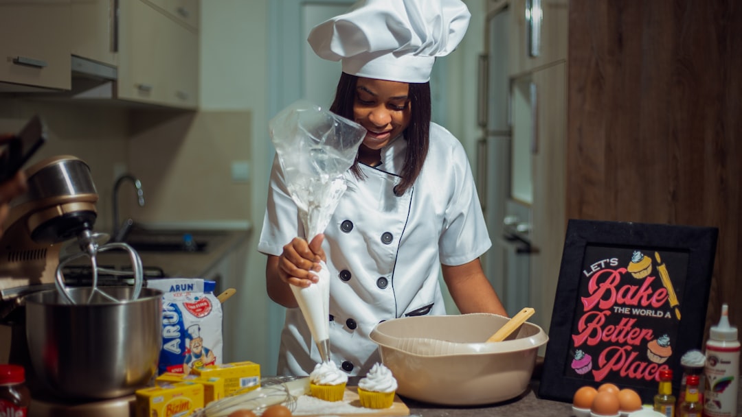 a woman in a chef's outfit preparing food in a kitchen