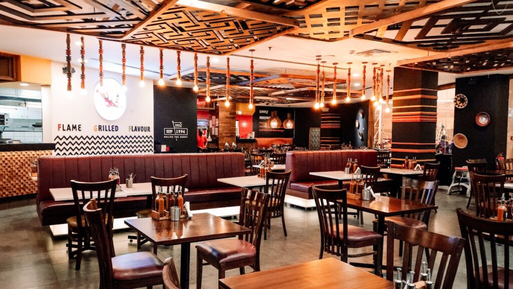 a restaurant filled with wooden tables and chairs