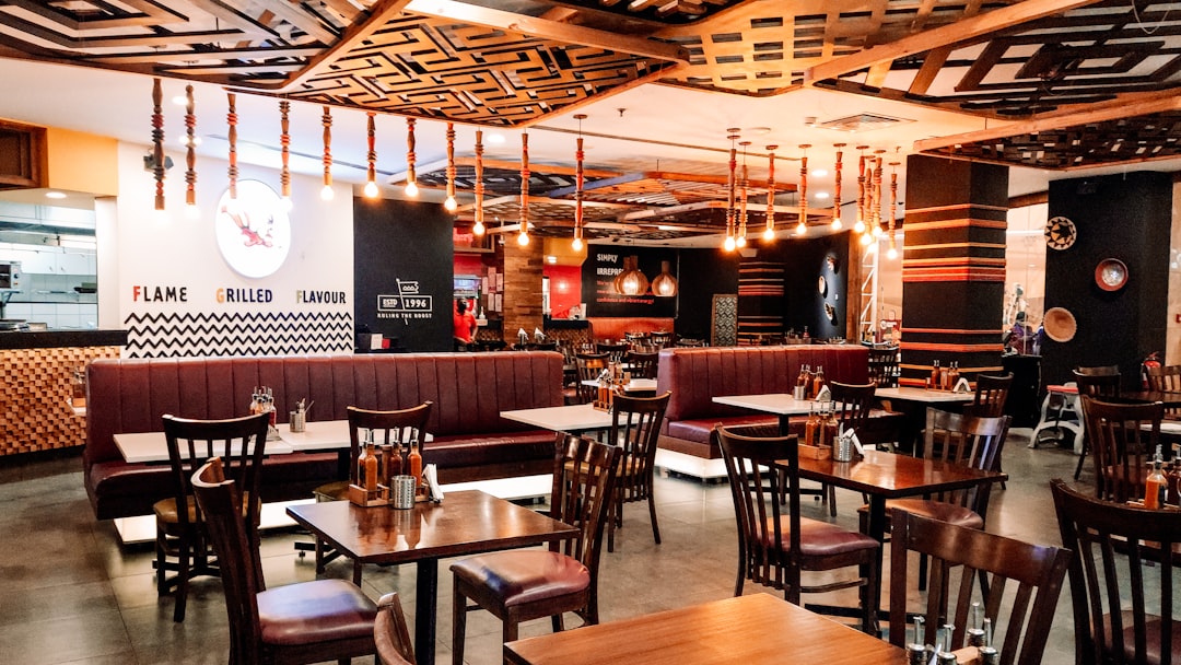 a restaurant filled with wooden tables and chairs