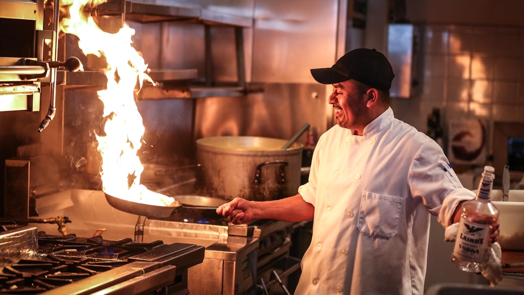 man in white chef uniform cooking