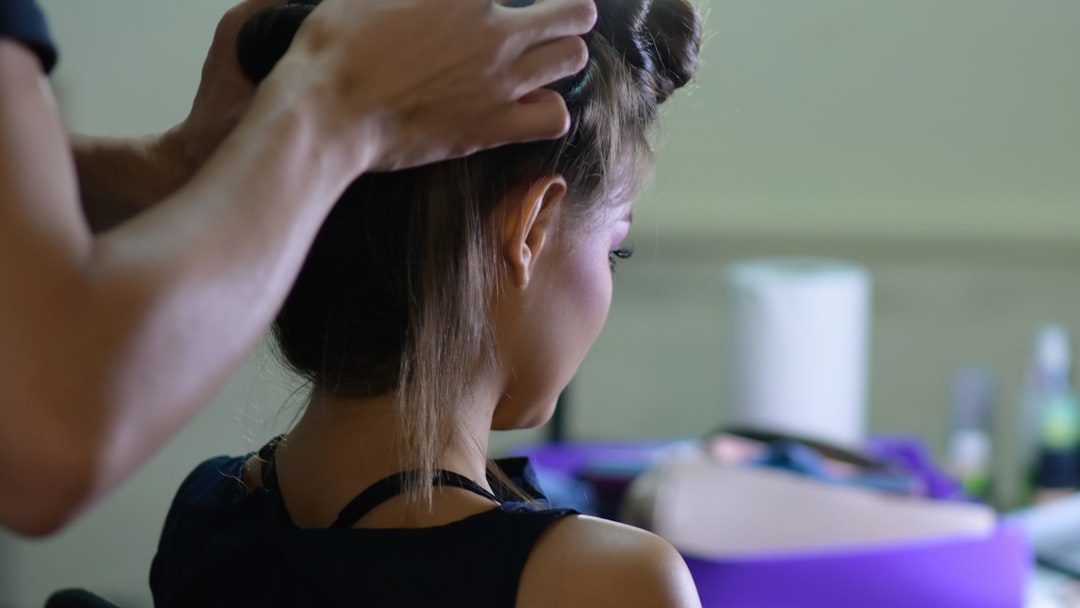 woman in black tank top holding her hair