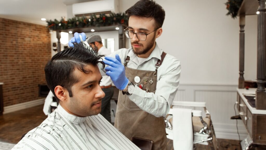man in white dress shirt cutting hair of man in white dress shirt