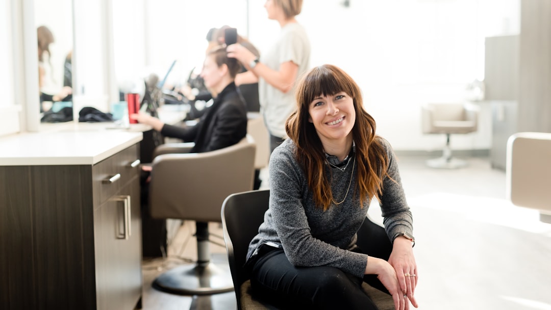 woman in gray long sleeve shirt and black pants sitting on black chair