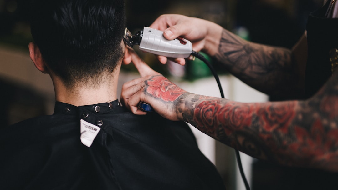 person using white hair clipper