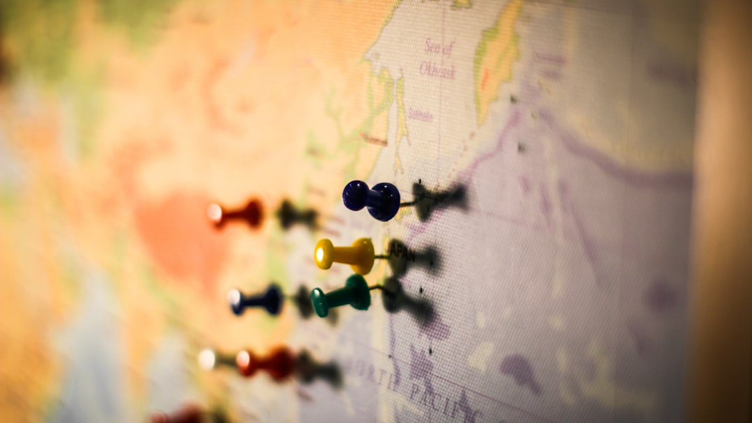 selective focus photography of push pin in map
