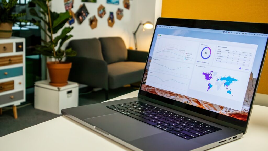 a laptop computer sitting on top of a white table
