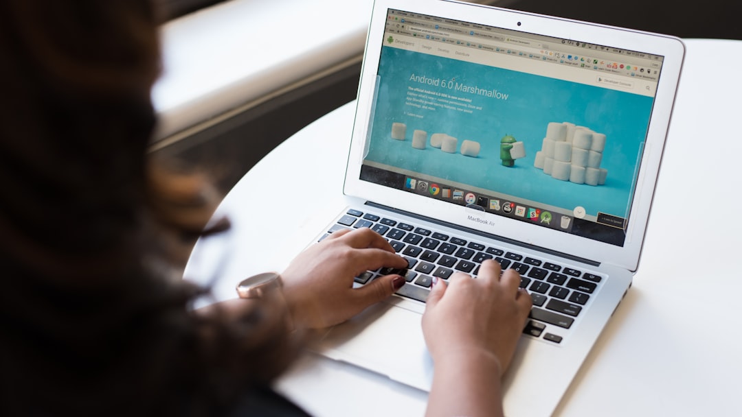 woman using MacBook Air on table